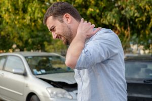 a man suffering from whiplash after a car accident